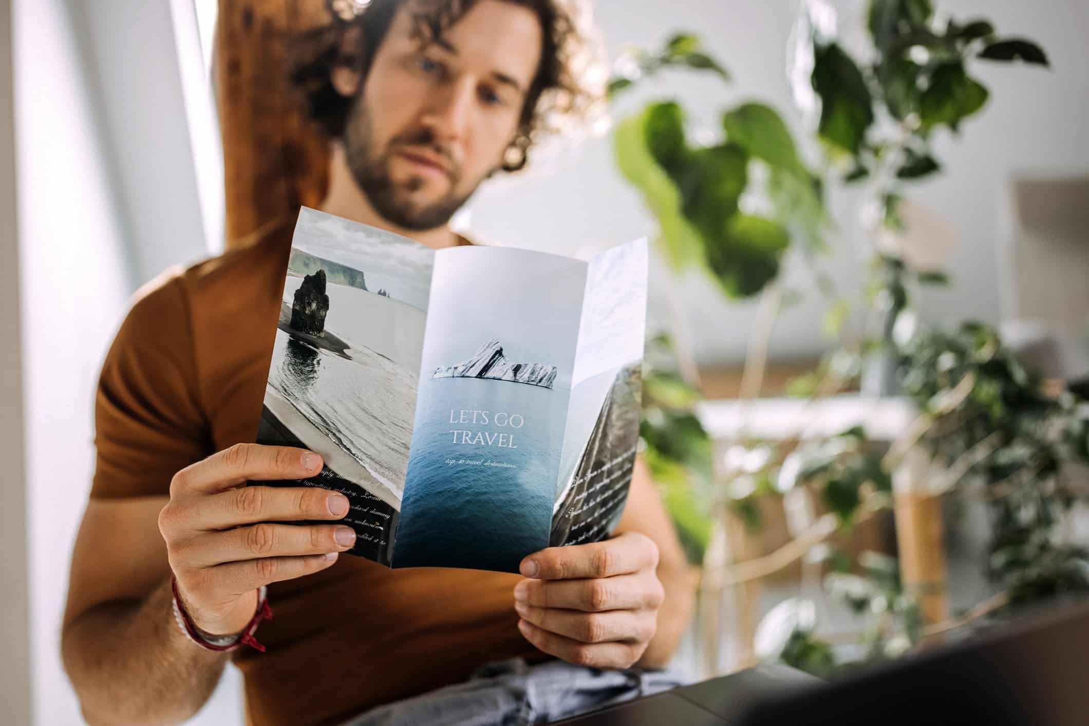 man reading travel leaflet for local estate agent